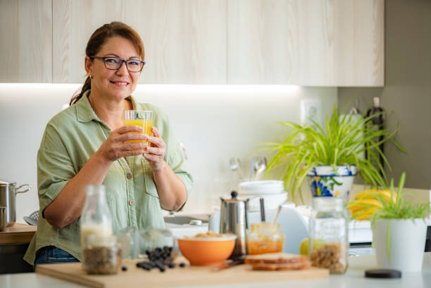 istock Confident woman drinking fruit juice at home 1494608694