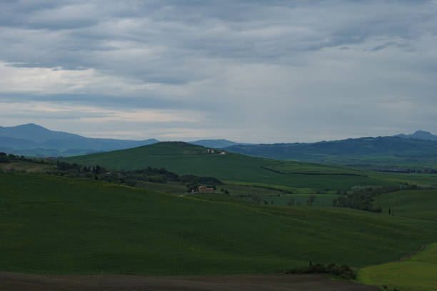 istock Tuscany fields in springtime, cloudy day mood, Val d'Orca, Pienza region 1494610379