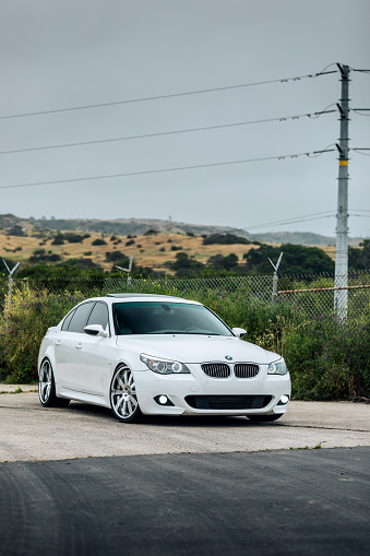 Seattle, WA, USA
May 23, 2023
White BMW M5 parked with at transmission line the background