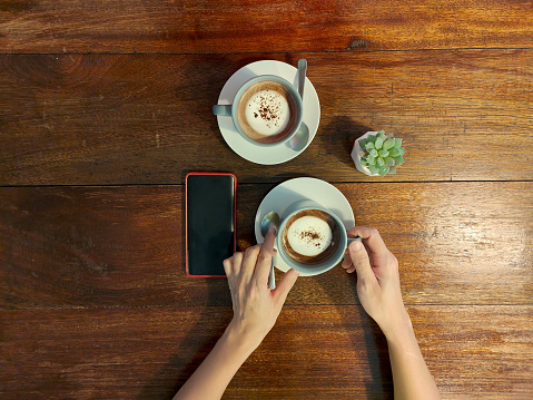 Coffee, smartphone on cafe table