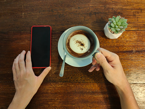 Coffee, smartphone on cafe table