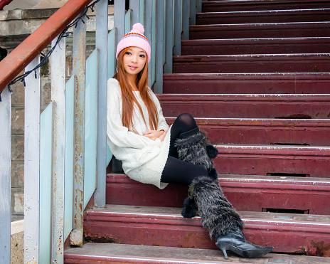 Portrait of Asian Taiwanese Woman in a beanie on a staircase