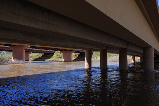 Bridge Over Colorado River - View from underneath bridge with high water flowing during spring runoff.