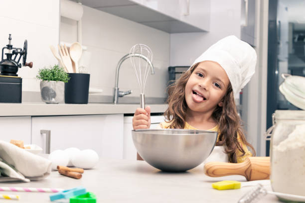 istock Sweet Moments: Girl preparing delicious cakes in cozy kitchen 1494617897
