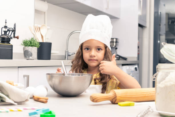 istock Pastry Perfection: Girl Showcasing her Culinary Talents in the Kitchen 1494617927