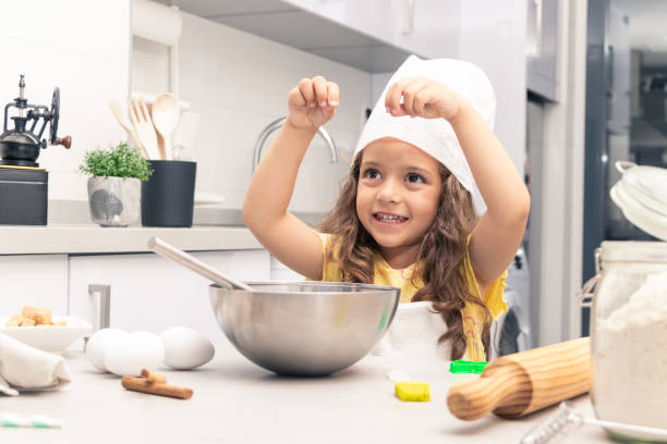istock Whisking Wonders: Girl Whipping Up Marvelous Desserts in the Kitchen 1494617936