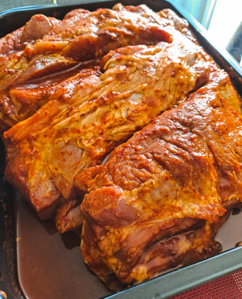 istock Peruvian christmas dinner. Marinated pork in a tray ready for oven. Chancho marinado para cena navideña. 1494620233