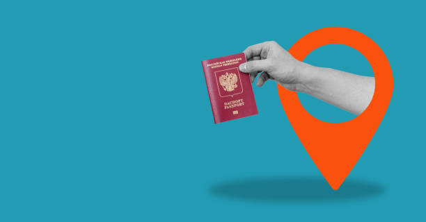 istock Art collage, the hand with Russian passport from navigation icon, on blue background with space for text. 1494621425
