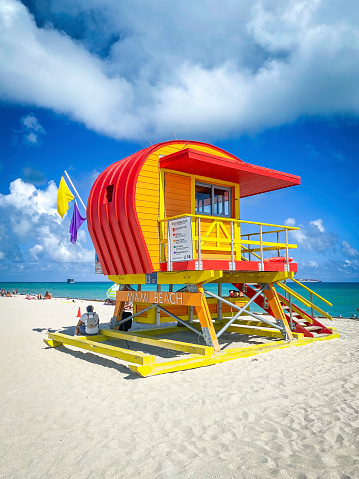 Colorful lifeguard tower at 13th street Miami Beach, Florida, USA against blue sky with clouds