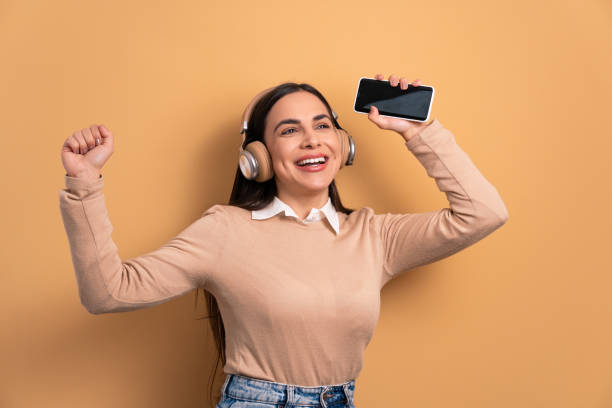 istock woman dancing with headphones 1494623010