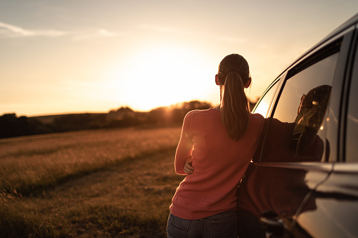 Female traveler enjoying sunset.
