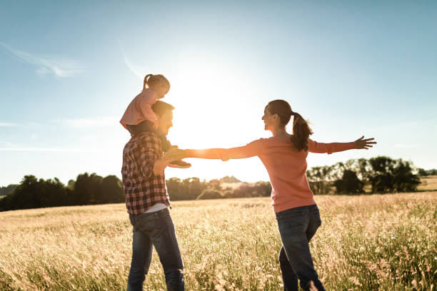 istock Happy family playing together in a field at sunset. 1494624975