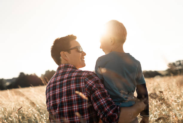 istock Happy father and son in nature field 1494624982