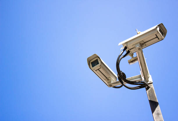 istock Surveillance cameras against the sky. Surveillance cameras, security. Video recording, security of objects. 1494625092