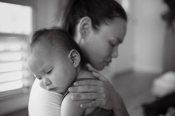 istock Tired stressed out mother holding her baby 1494625216