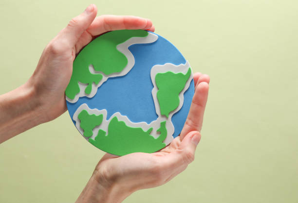 istock Female hands hold planet earth on green background. Save the planet 1494625272