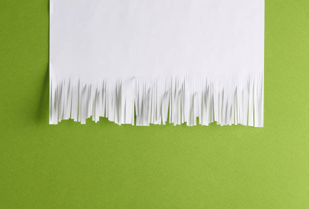 White cut shredded paper on green background stock photo