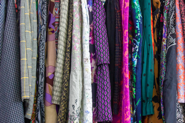 istock Clothing store background.Clothes on hangers background. Multi-colored textiles, fabric, clothes, t-shirts, shirts, dresses. 1494626013