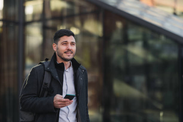 istock Smiling Businessman Using A Mobile Phone In The City 1494628469