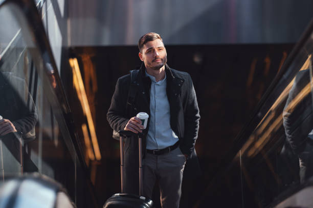 istock Handsome Businessman Riding Escalator At Subway Station 1494628580