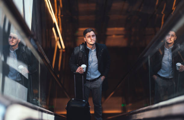istock Serious Businessman Riding Escalator At Subway Station 1494628593