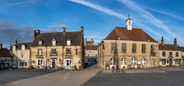 Helmsley, North Yorkshire, UK - May 29, 2023.  Landscape panorama of the market square and Town Hall in the popular Yorkshire tourist destination of Helmsley