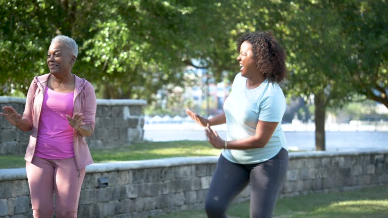 Senior woman and Hispanic friend doing dance workout