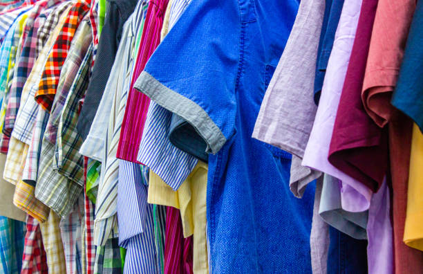 istock Clothing store background.Clothes on hangers background. Multi-colored textiles, fabric, clothes, t-shirts, shirts, dresses. 1494630097