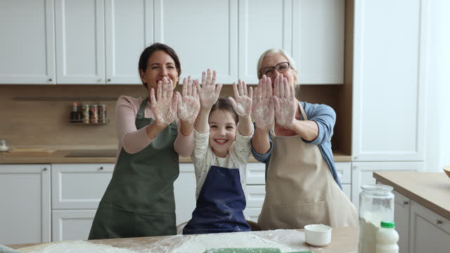 Multigenerational family having fun while prepare dough for homemade pastries