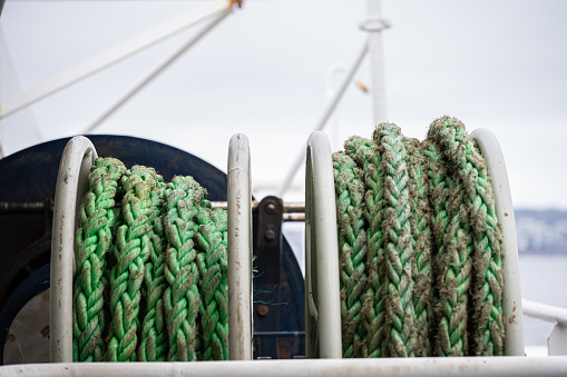 Green docking lines on drums on a ferry.