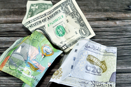 Wrinkled, crumpled Saudi Arabia, Kuwaiti half dinar money 20 SAR twenty riyals, 1 one American dollar cash, Money inflation and losing value, drop concept, business and market crisis, global problems, selective focus