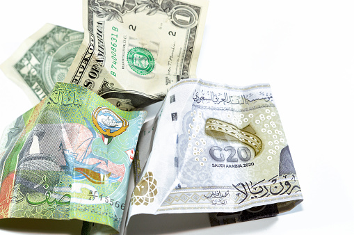 Wrinkled, crumpled Saudi Arabia, Kuwaiti half dinar money 20 SAR twenty riyals, 1 one American dollar cash, Money inflation and losing value, drop concept, business and market crisis, global problems, selective focus