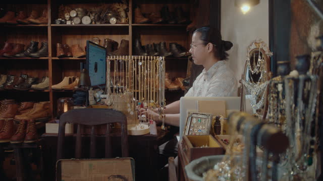 Asian Man Working on Computer in Antique Store