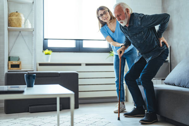 istock Smiling nurse assisting senior man to get up from bed. 1494644102