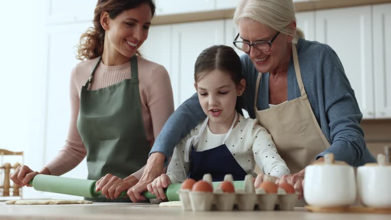 Multigenerational women and child prepare home-made pastry