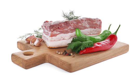 Piece of pork fatback served with different ingredients isolated on white