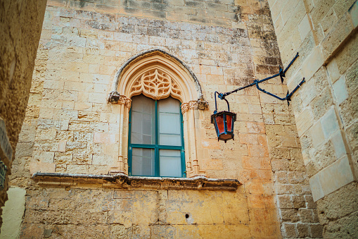 Decorated window and old ancient architecture in the beautiful town of Mdina, Malta