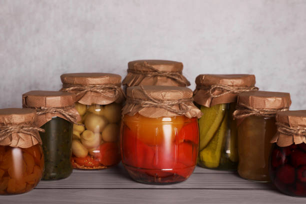 istock Many glass jars with different preserved products on wooden table 1494648565