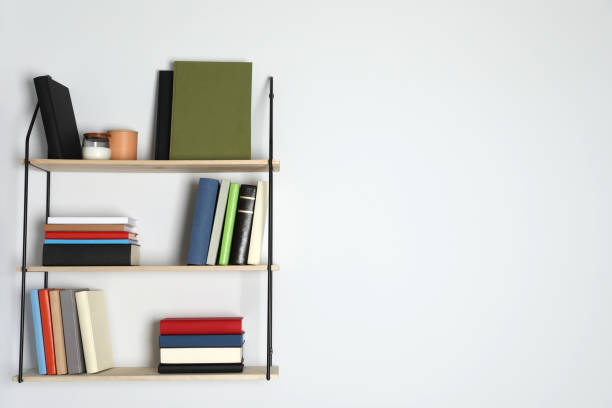 istock Shelves with many hardcover books on white wall. Space for text 1494648980