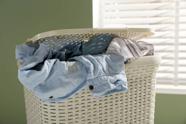 istock Plastic laundry basket with clothes indoors, closeup 1494649020