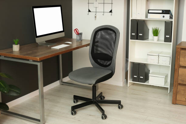 istock Stylish office interior with comfortable chair, desk and computer 1494649077