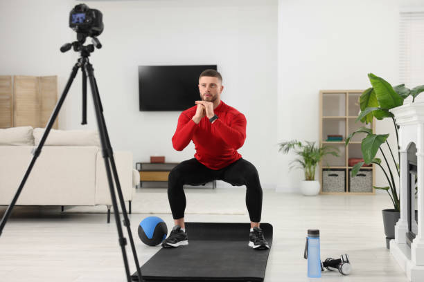 istock Trainer recording workout on camera at home 1494650308