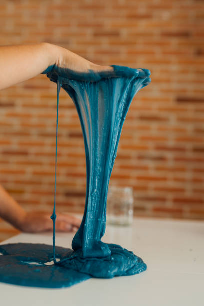 istock Little boy playing with sticky slime on the table at home 1494650447