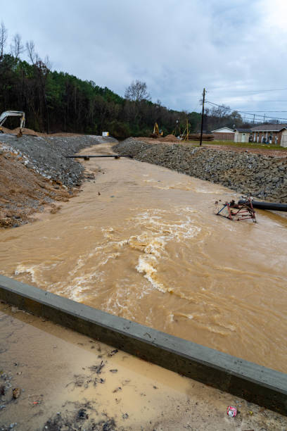 istock Construction equiment under fast moving water along a rocky embankment. 1494653554