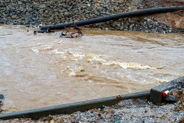 istock Construction equiment under fast moving water along a rocky embankment. 1494653557