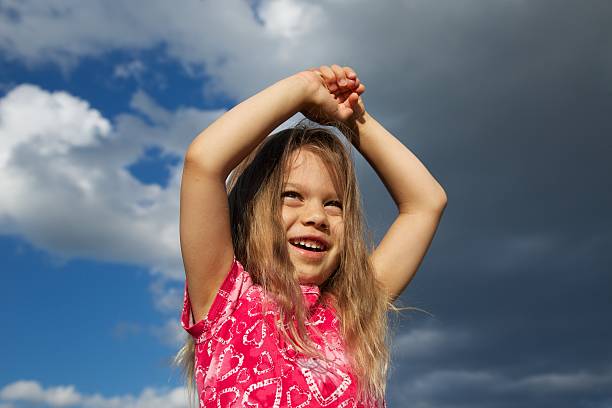 istock Excited Young Girl against Cloudy Sky 149465808