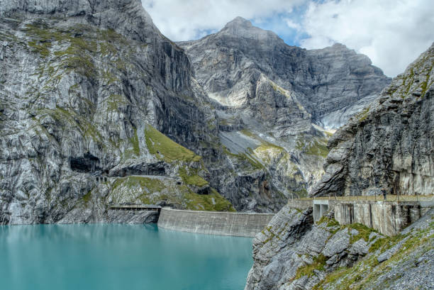 View of the Limmernsee dam in the canton of Glarus. Hiking high above the mountain lake in the Alps. Limmernsee Lake, Glarus, Switzerland stock photo