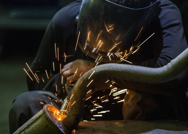 istock Welder repairing a car exhaust pipe 1494661751