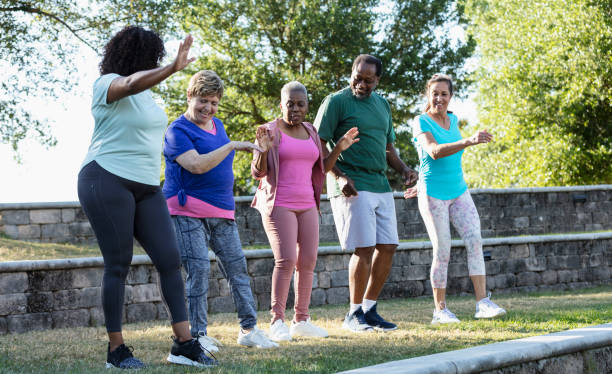 istock Mature and senior adults taking exercise class in park 1494661908