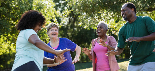 istock Multiracial adults in group exercise class at park 1494661912